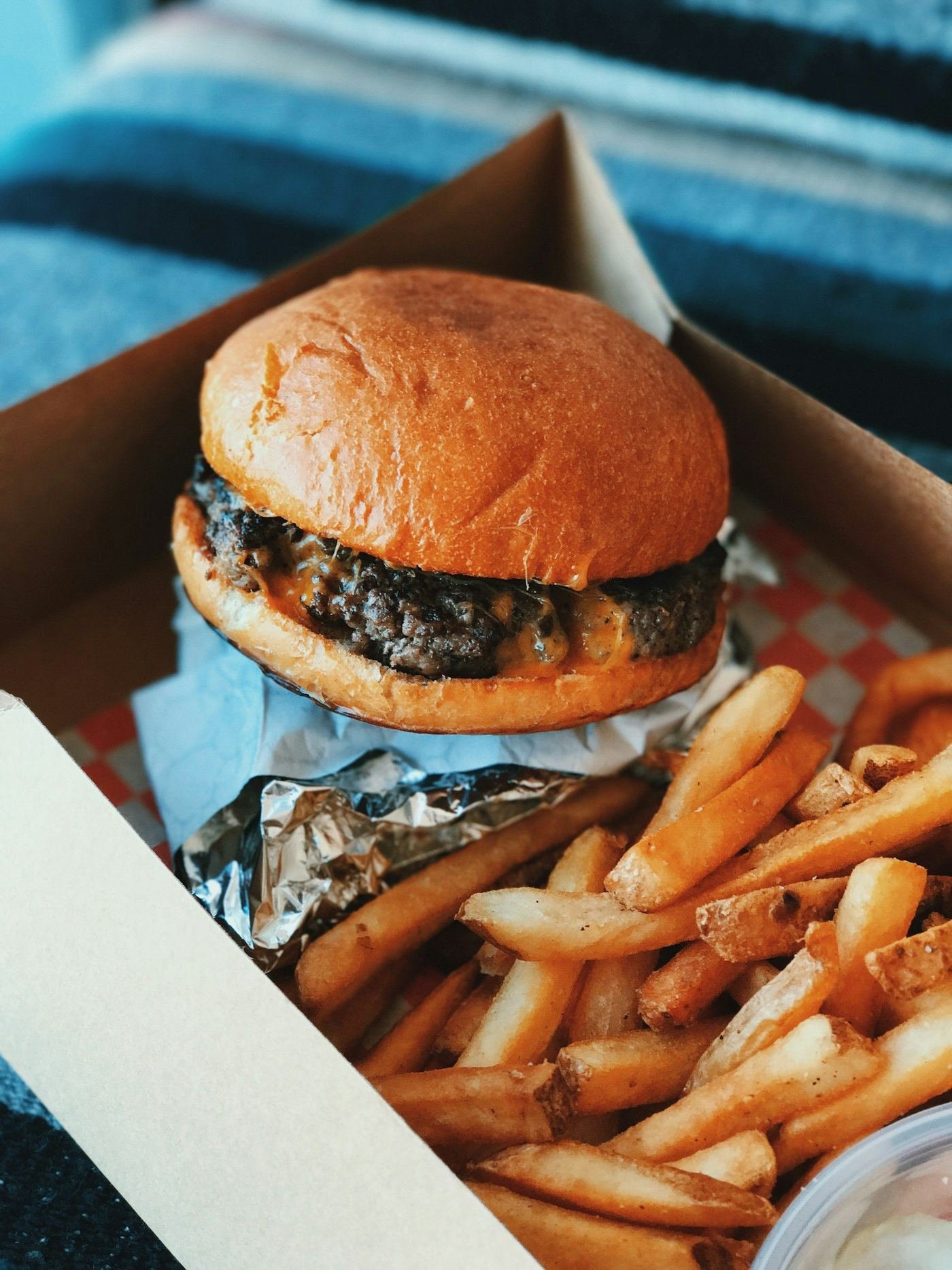 Burger and fries packed in a takeaway box for delivery