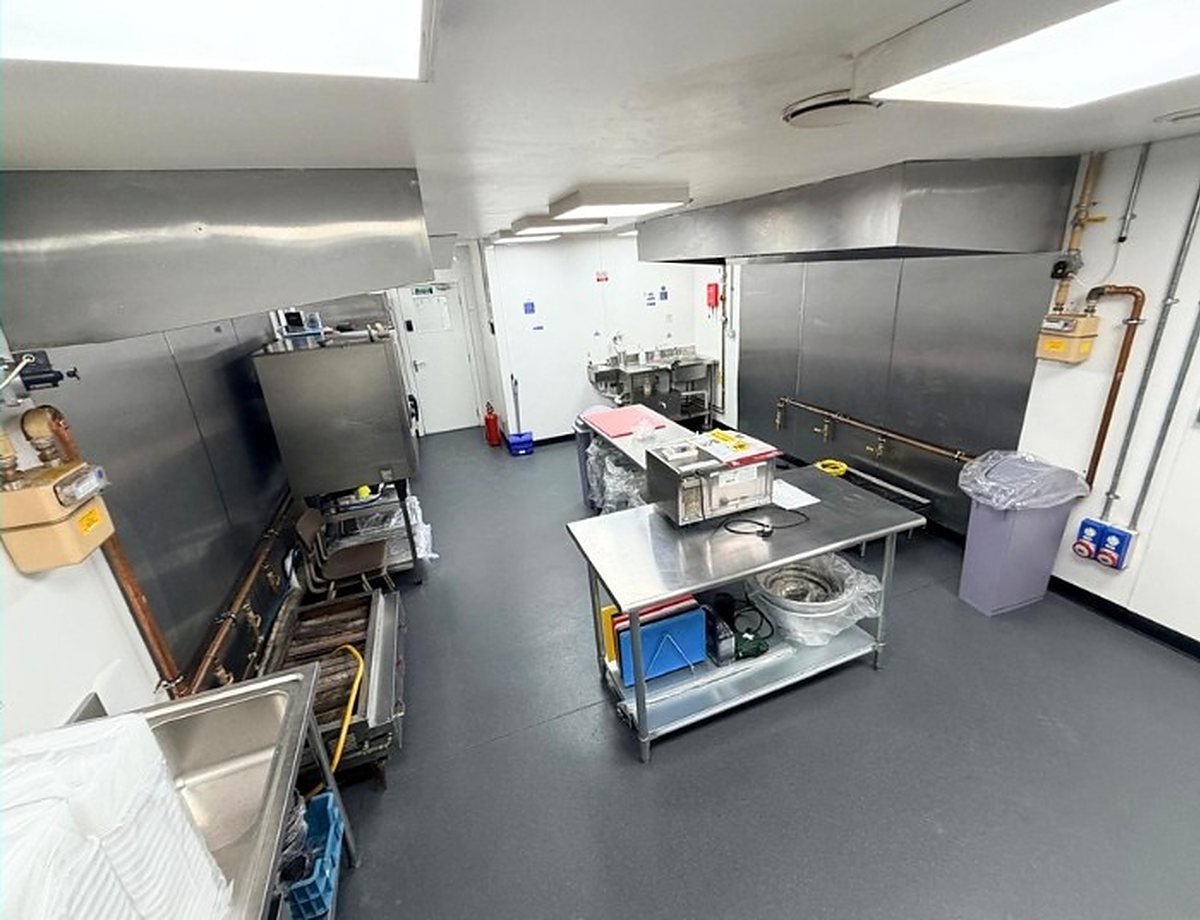 A Ready Kitchen unit fitted out by a member with stainless benches, cooking equipment and prep stations